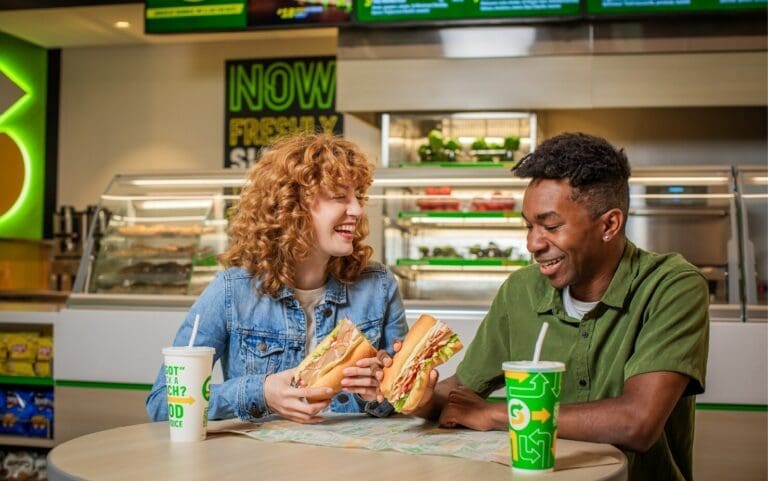 Subway customers enjoying their meals in the store, highlighting the importance of email marketing in building customer loyalty.